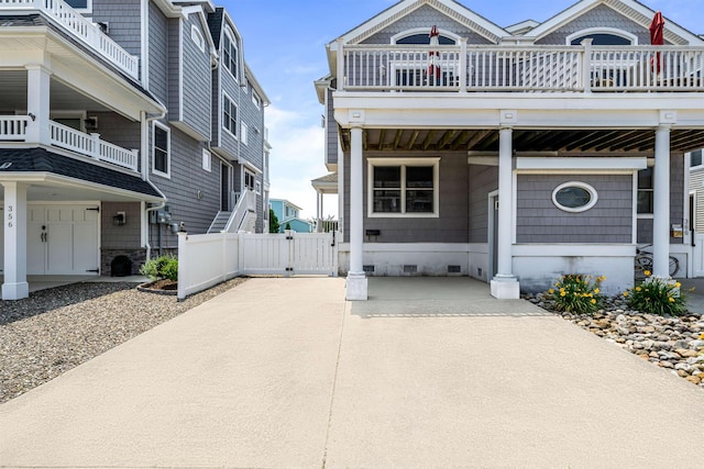 364 41st St E, Unit East, Avalon, NJ 08202 - view of front of property featuring a gate, crawl space, a balcony, and concrete driveway