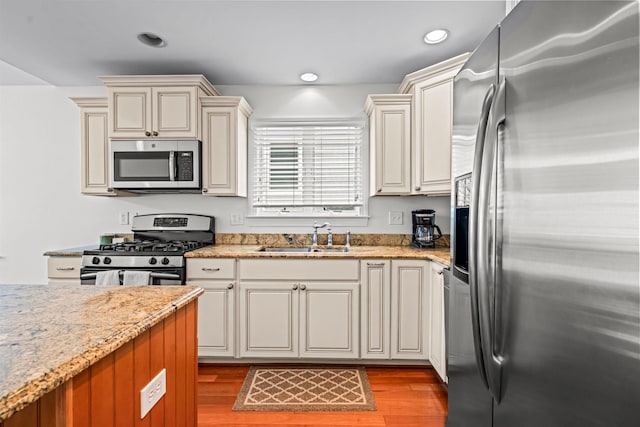 364 41st St E, Unit East, Avalon, NJ 08202 - kitchen with appliances with stainless steel finishes, light wood-style floors, recessed lighting, light stone counters, and cream cabinets