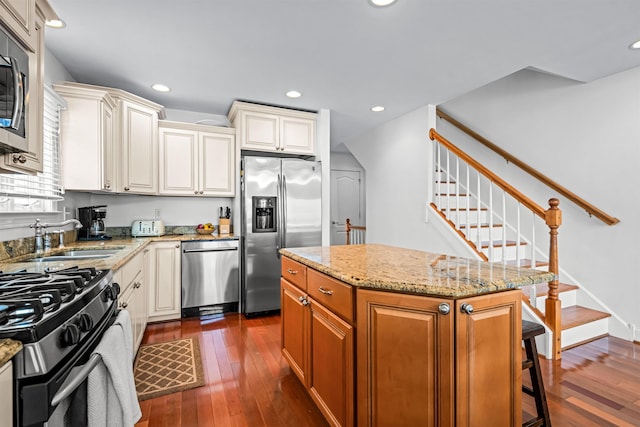 364 41st St E, Unit East, Avalon, NJ 08202 - kitchen featuring stainless steel appliances, dark wood-style flooring, light stone counters, a center island, and recessed lighting