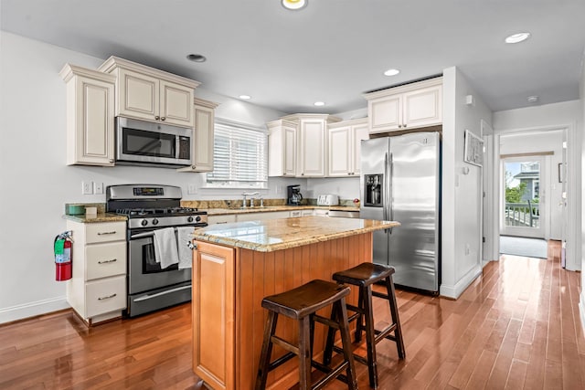 364 41st St E, Unit East, Avalon, NJ 08202 - kitchen featuring appliances with stainless steel finishes, wood finished floors, healthy amount of natural light, a center island, and recessed lighting