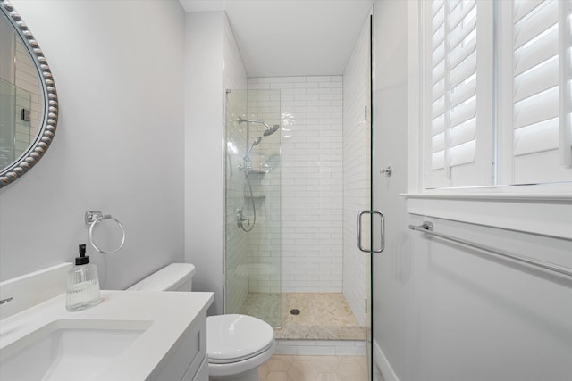 full bathroom featuring a stall shower, tile patterned flooring, vanity, and toilet