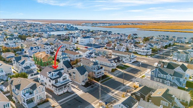 birds eye view of property featuring a residential view and a water view