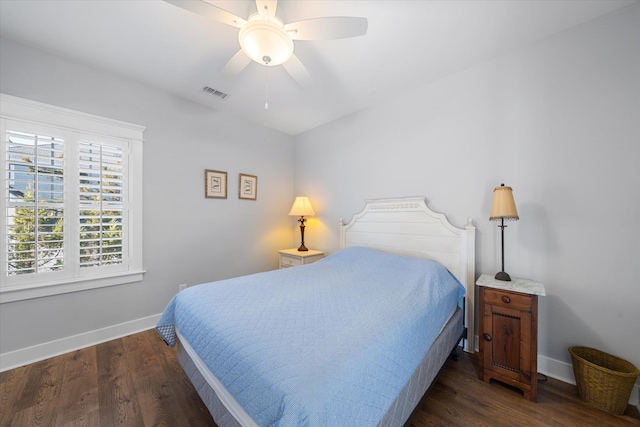 bedroom featuring dark wood-style floors, baseboards, visible vents, and a ceiling fan