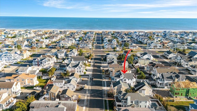 birds eye view of property with a water view and a residential view