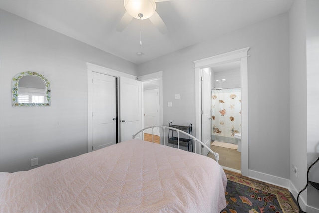 bedroom with ceiling fan, ensuite bath, and baseboards