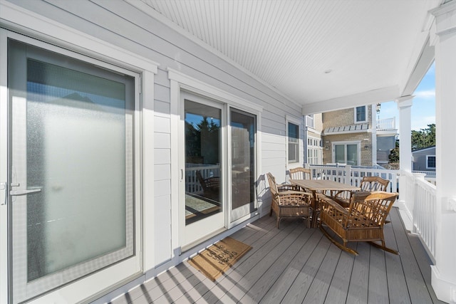 wooden terrace featuring outdoor dining area