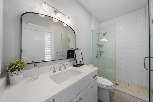 bathroom featuring a stall shower, vanity, and toilet