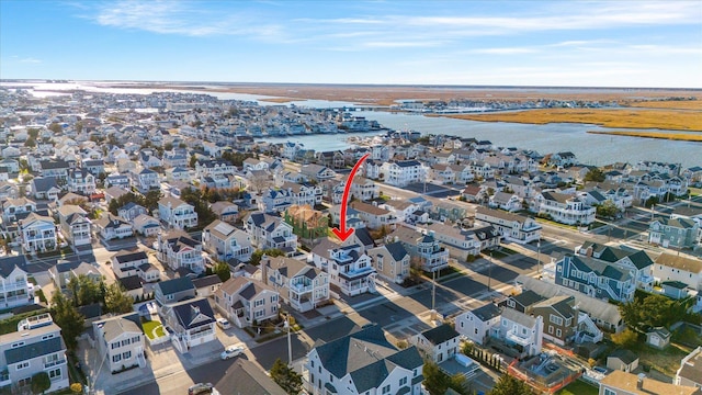 bird's eye view with a residential view and a water view