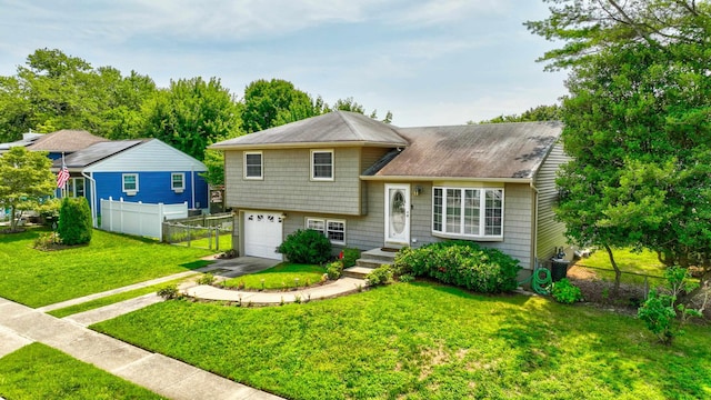 split level home featuring a front lawn and a garage