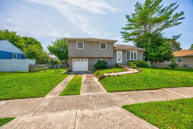 split level home featuring a front lawn and a garage