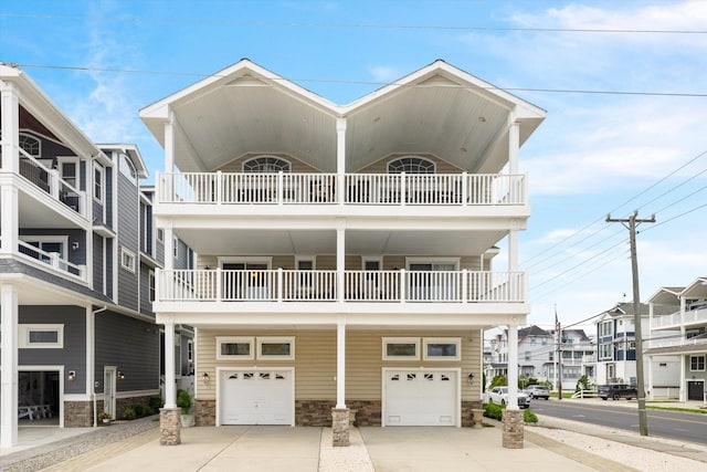 32 47th St E Unit, East Unit, Sea Isle City, NJ 08243 - view of front of home featuring a garage, concrete driveway, and a residential view