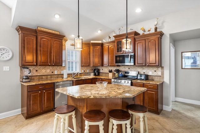 32 47th St E Unit, East Unit, Sea Isle City, NJ 08243 - kitchen with appliances with stainless steel finishes, a breakfast bar, backsplash, light stone countertops, and lofted ceiling