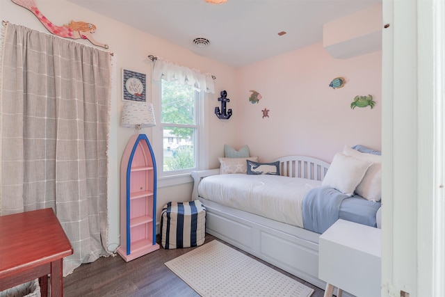 bedroom with dark wood-type flooring and visible vents