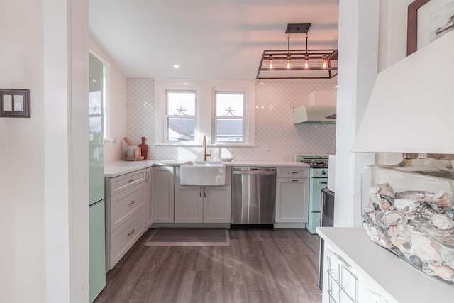 kitchen featuring dark wood finished floors, a sink, extractor fan, gas range oven, and dishwasher