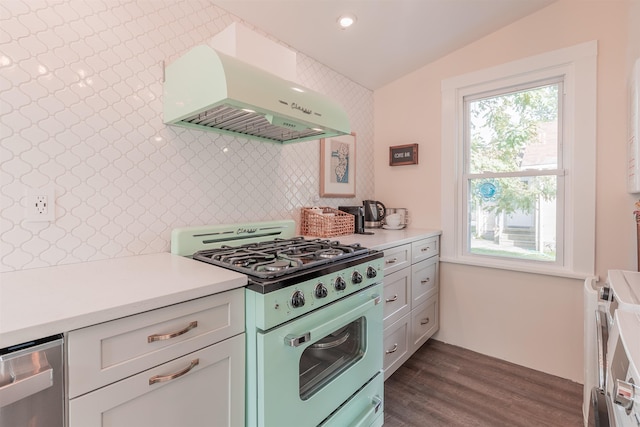 kitchen featuring dark wood finished floors, decorative backsplash, light countertops, under cabinet range hood, and gas range