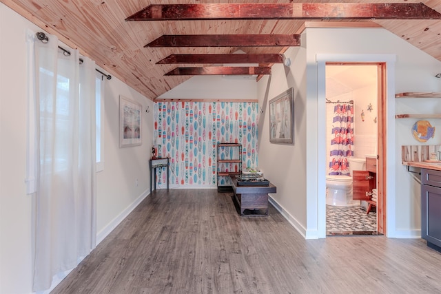 interior space with wood finished floors, vaulted ceiling with beams, wood ceiling, and baseboards