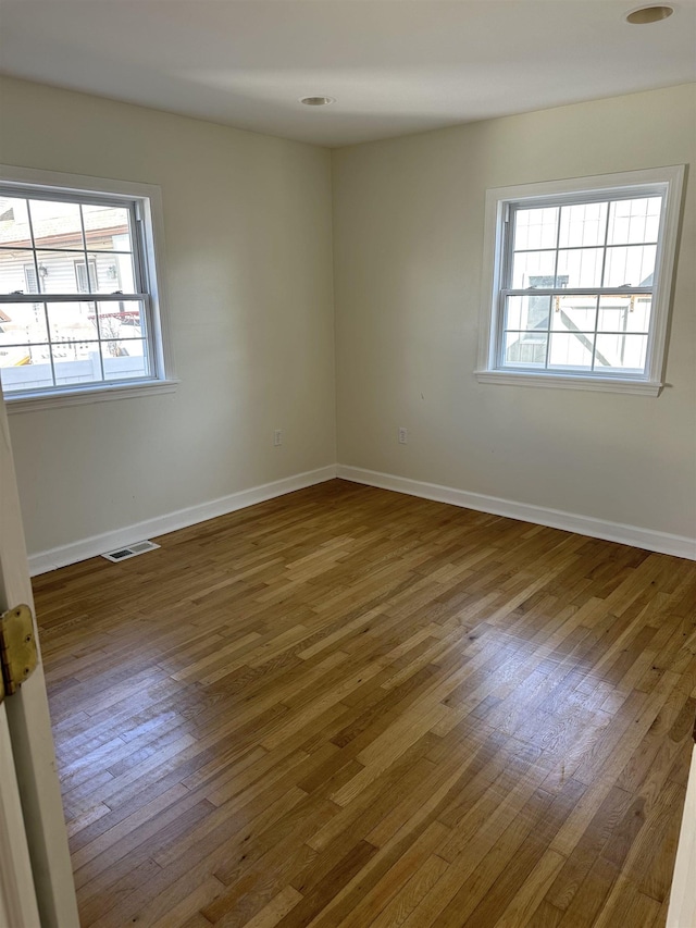 empty room with dark wood-type flooring