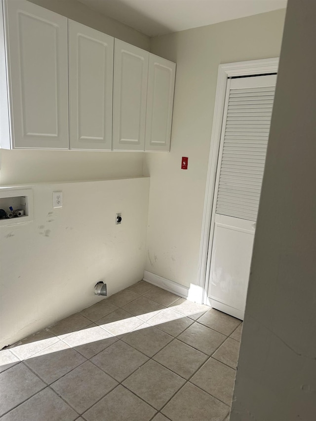 laundry room featuring electric dryer hookup, light tile patterned flooring, cabinets, and hookup for a washing machine