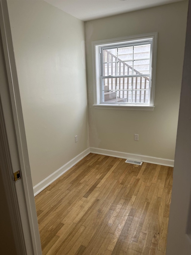 spare room with light hardwood / wood-style flooring