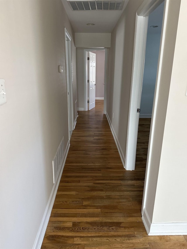 hallway featuring dark hardwood / wood-style flooring