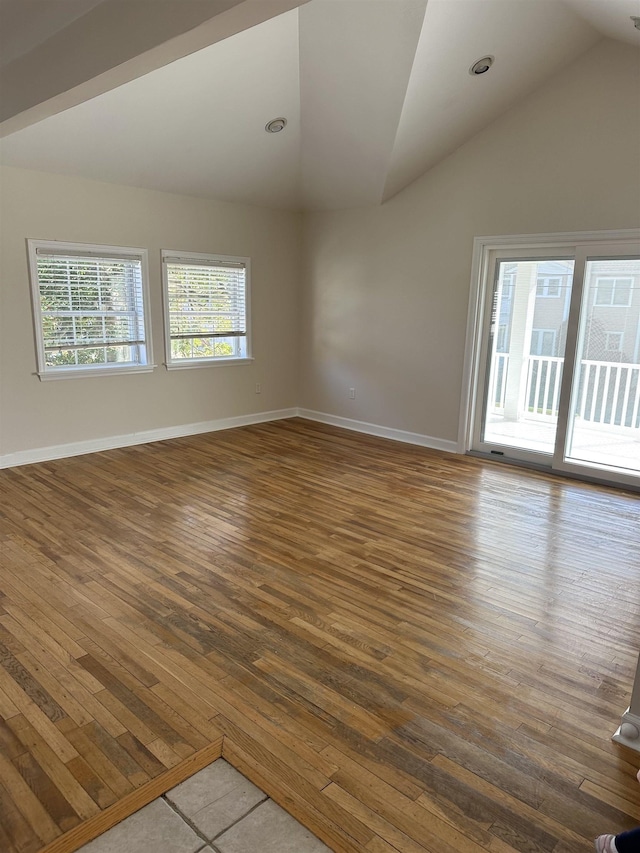 empty room featuring hardwood / wood-style floors and lofted ceiling