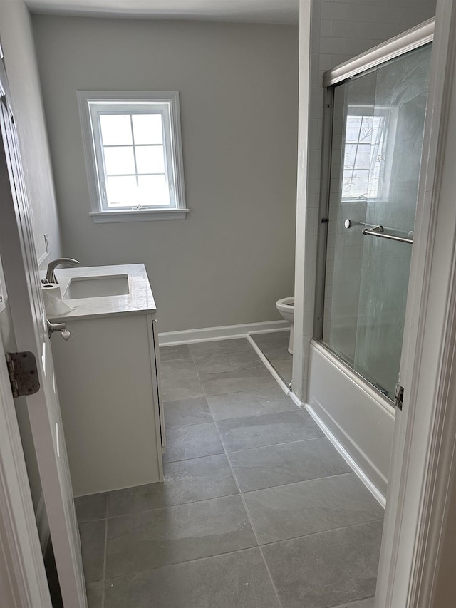 full bathroom with shower / bath combination with glass door, tile patterned flooring, vanity, and toilet