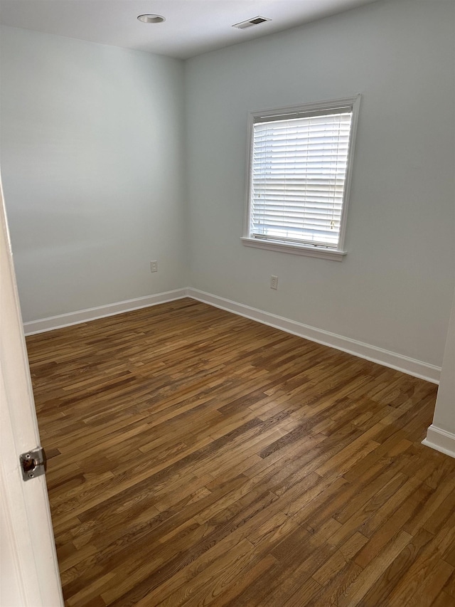 unfurnished room featuring dark hardwood / wood-style flooring