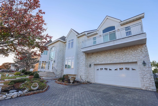 townhome / multi-family property with a balcony and a garage