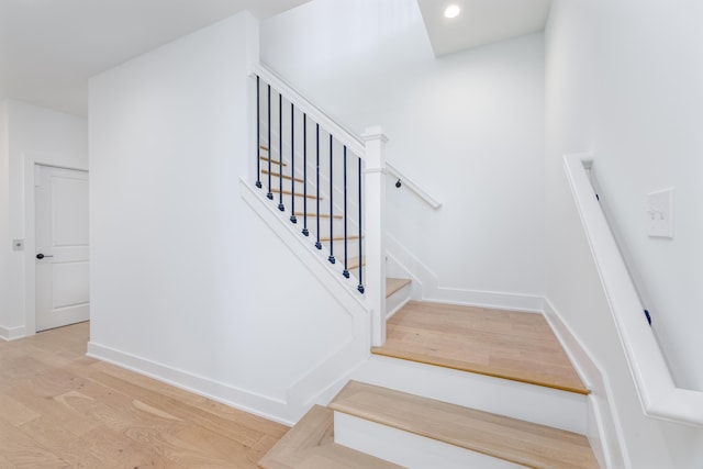 stairway featuring wood-type flooring