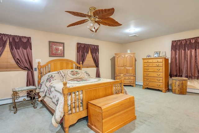 bedroom with ceiling fan, light colored carpet, and a baseboard heating unit