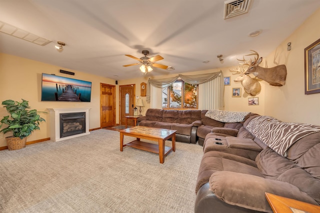 carpeted living room with ceiling fan