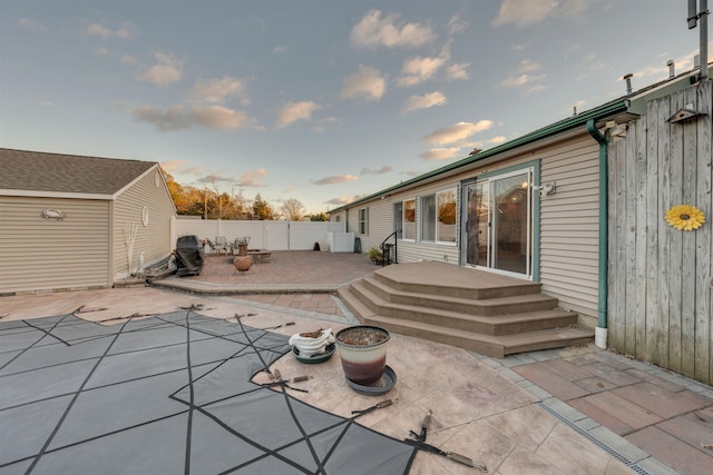 view of patio terrace at dusk