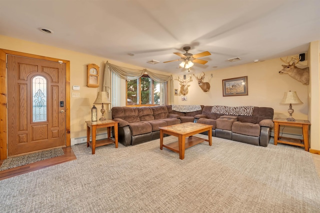 living room featuring ceiling fan and baseboard heating