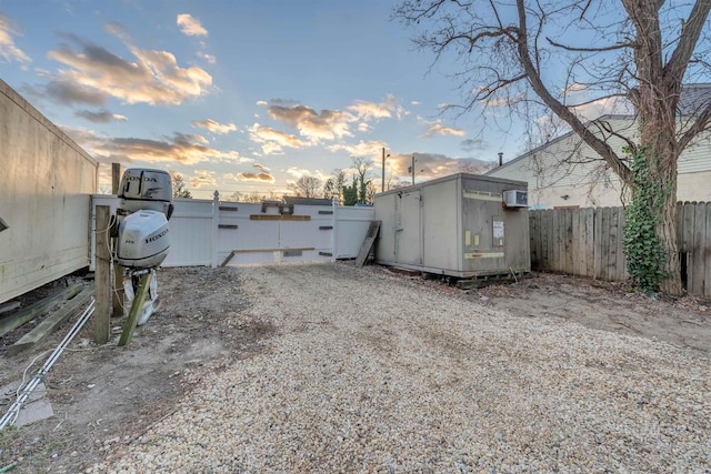 yard at dusk with a storage shed