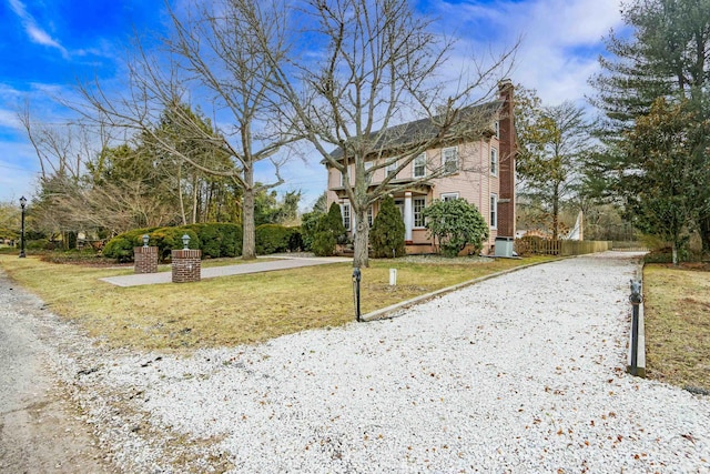 view of front of house with a chimney and a front yard