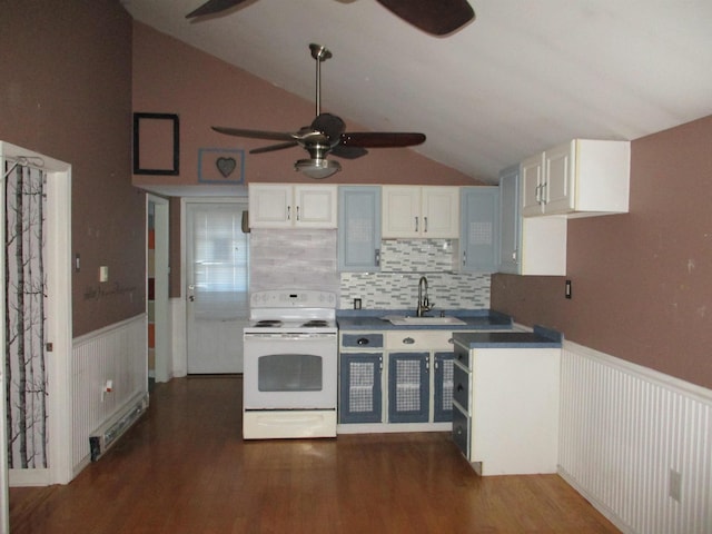 kitchen with white range with electric cooktop, sink, white cabinets, and vaulted ceiling