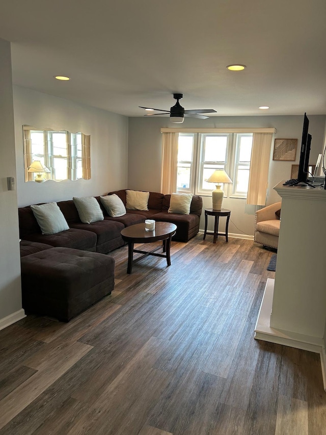 living room with dark hardwood / wood-style floors and ceiling fan