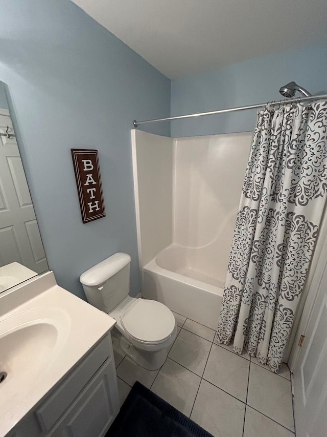 full bathroom with tile patterned flooring, shower / tub combo, vanity, and toilet