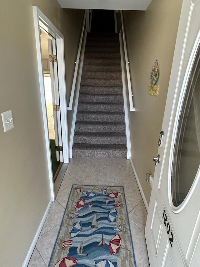 staircase featuring tile patterned flooring