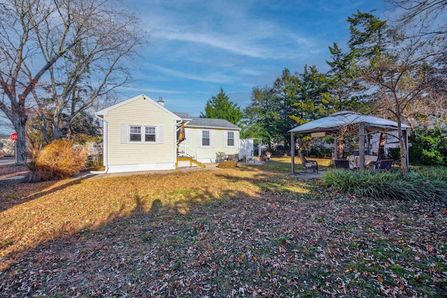 rear view of house featuring a gazebo