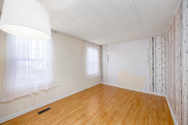 unfurnished room featuring hardwood / wood-style flooring