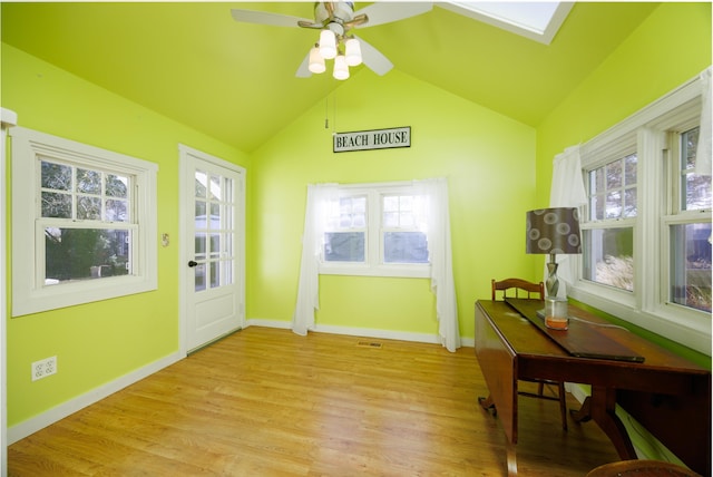 doorway featuring ceiling fan, light hardwood / wood-style flooring, and lofted ceiling