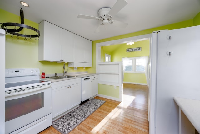 kitchen featuring white appliances, sink, ceiling fan, light hardwood / wood-style floors, and white cabinetry