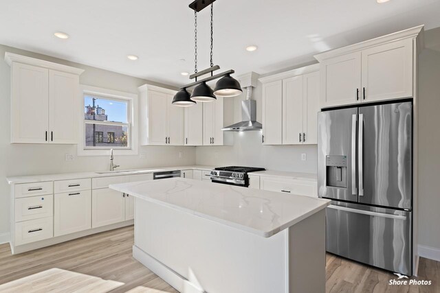 3130 Pacific Ave Unit 3130, Wildwood, NJ 08260 - kitchen with stainless steel appliances, wall chimney range hood, a sink, a center island, and white cabinets