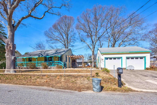 view of front of house featuring fence, a porch, a garage, driveway, and a pergola