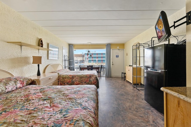 bedroom featuring black fridge