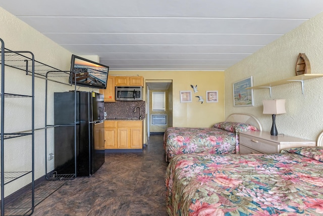 bedroom featuring black fridge