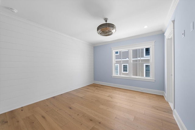 unfurnished room with light wood-style floors, baseboards, and ornamental molding