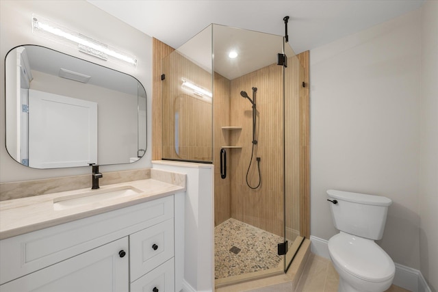 full bathroom featuring a stall shower, baseboards, vanity, and toilet