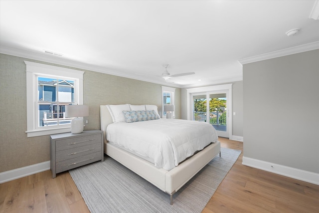 bedroom with light wood-style floors, access to outside, visible vents, and baseboards